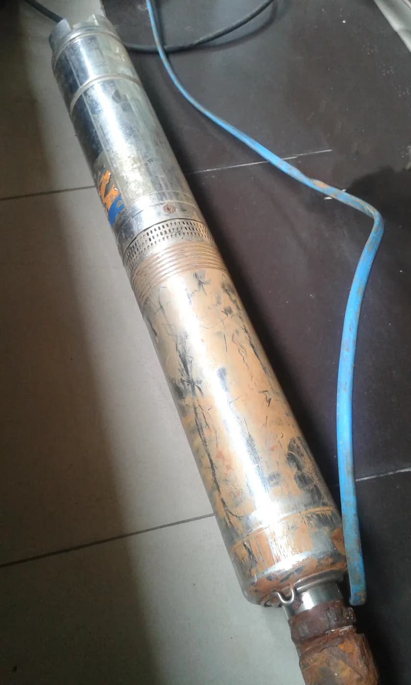 Deep well submersible pump showing the stainless steel stage stack, suction interconnector and submersible motor